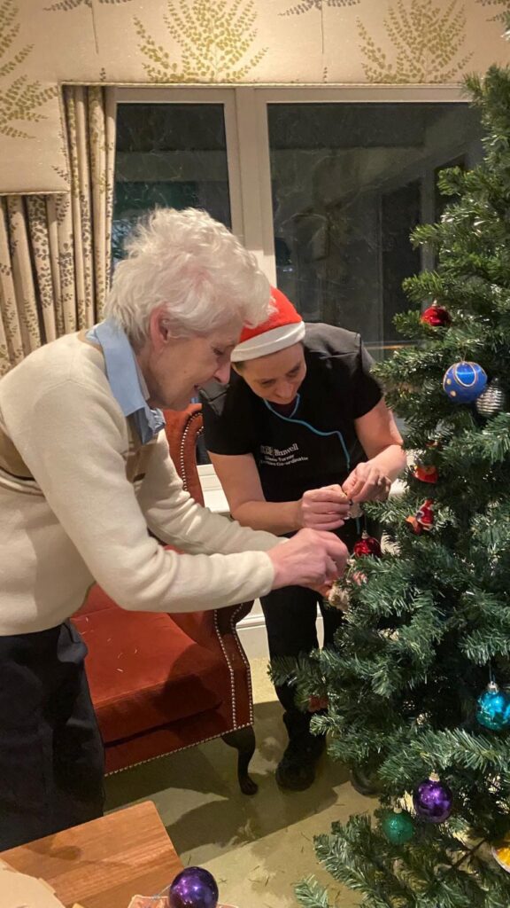 resident and team member decorating our tree