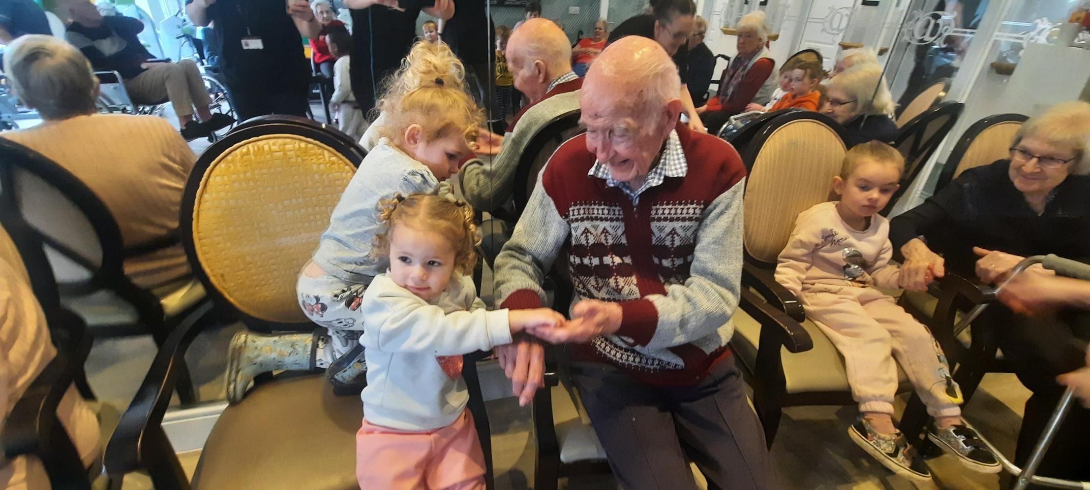 residents spending time with nursery children