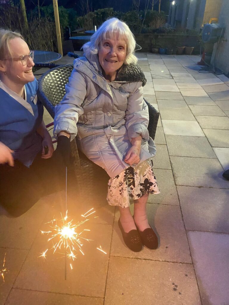 resident outside with a sparkler enjoying chinese new year