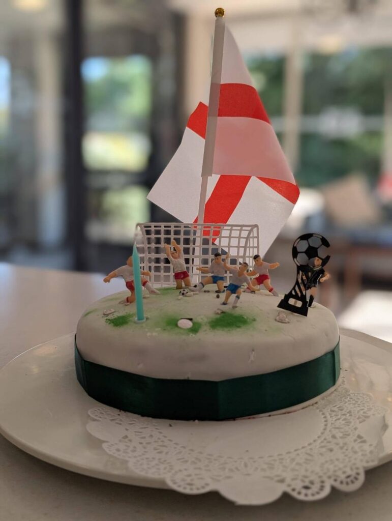 a birthday cake with an england flag and football decorations