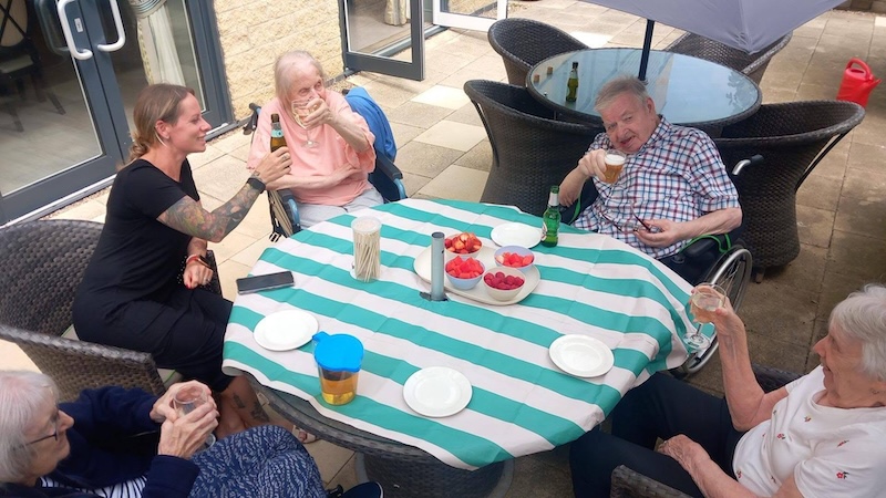 our residents sat in the garden enjoying some fruit and a drink together