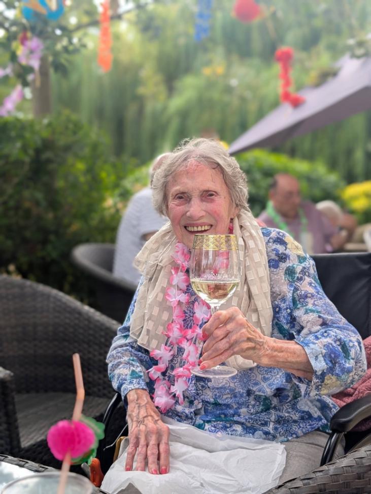 older lady holding a wine glass