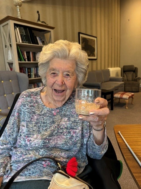 older lady holding up a wine glass